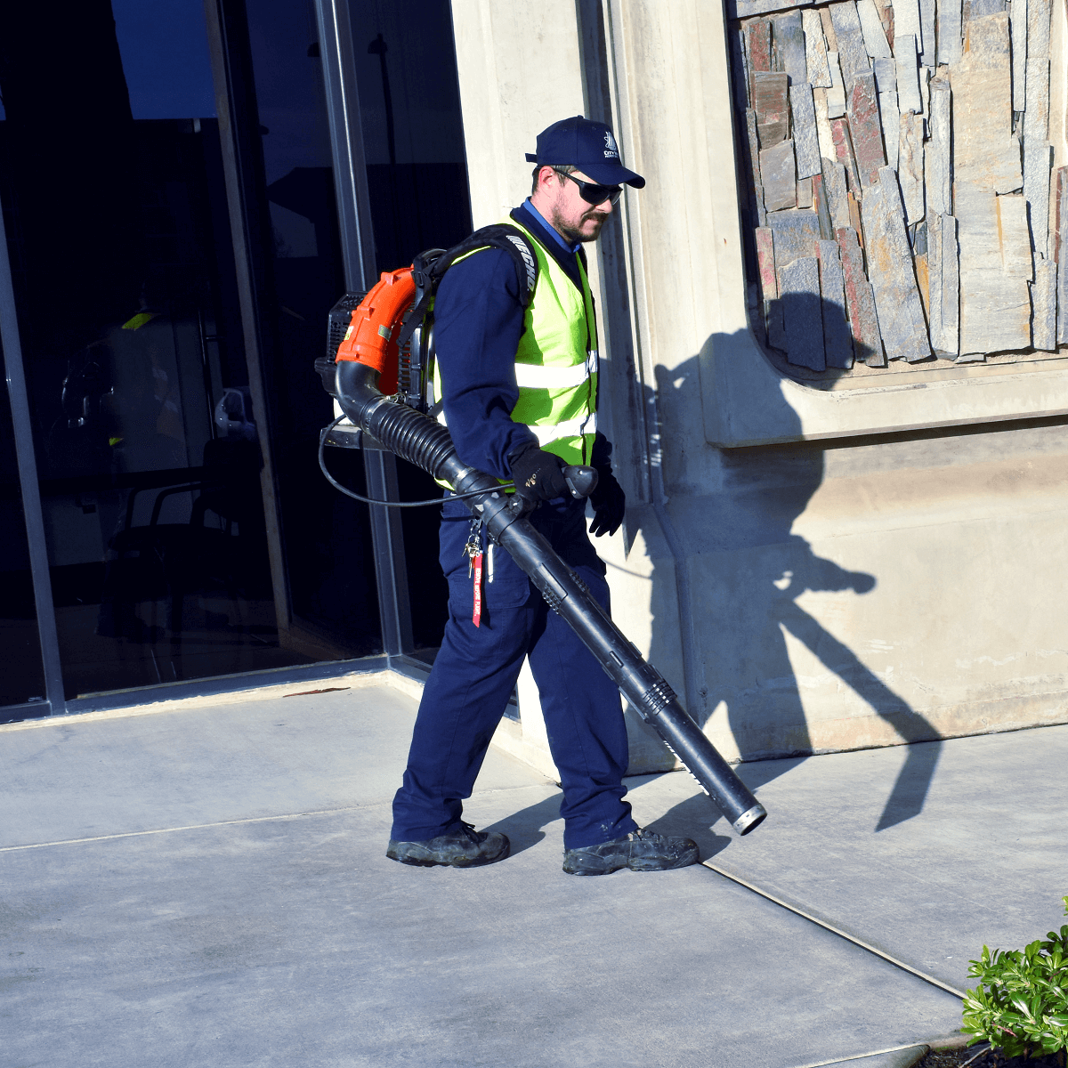 Landscape technician blowing leaves