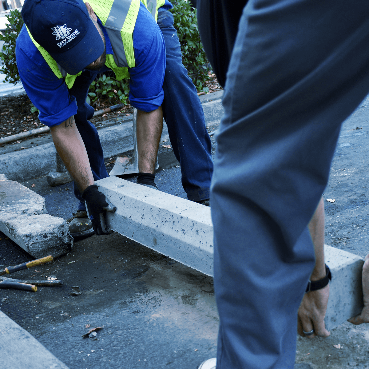 Close-up of techs moving parking curb